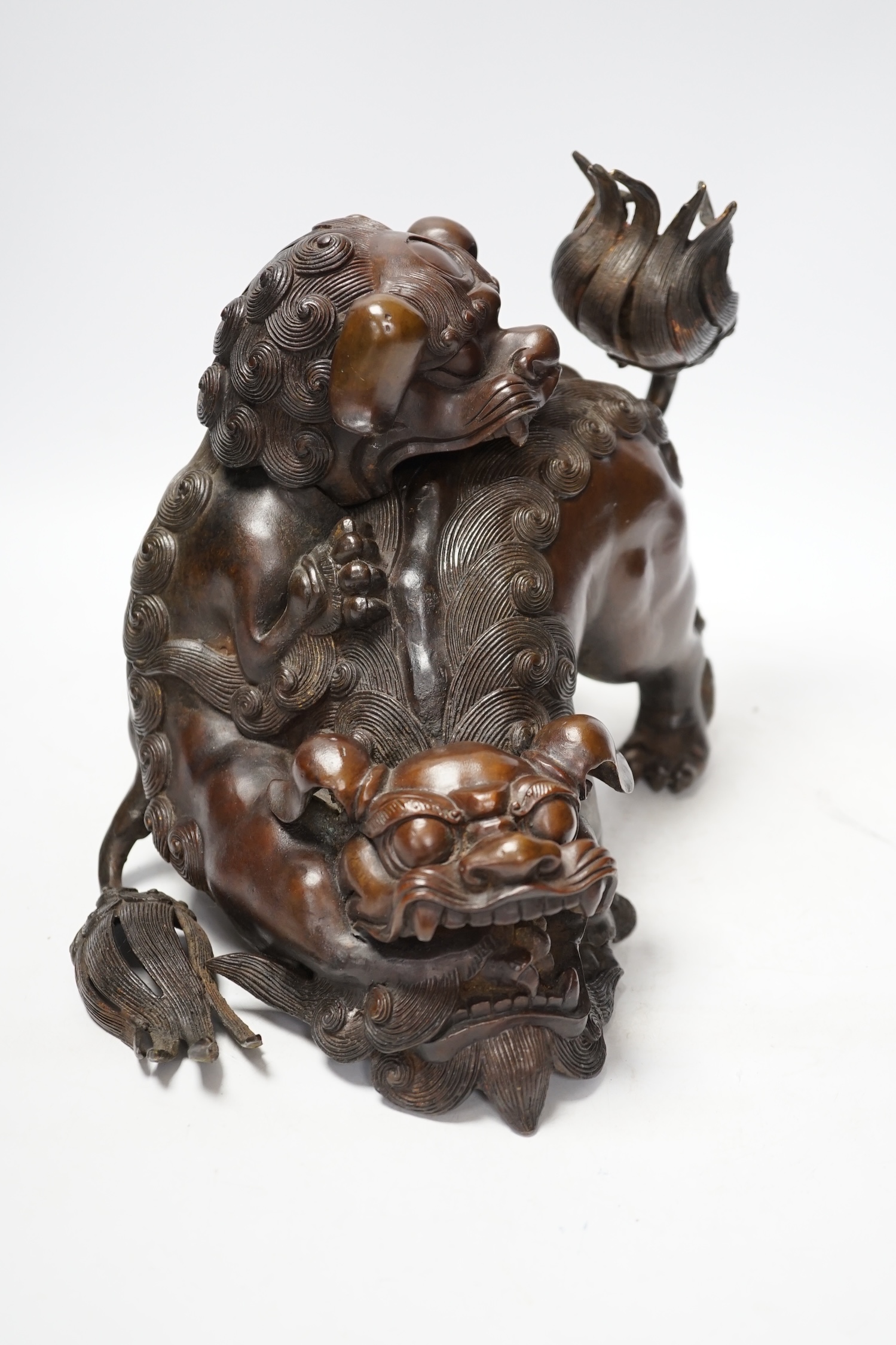 A large Chinese bronze incense burner, modelled as 2 lion dogs playing, 19th century, 22cm high. Condition - good